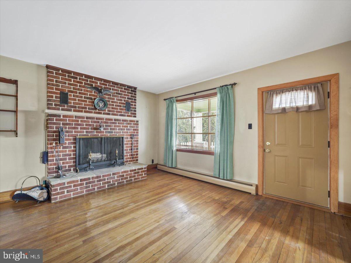 7220 Slabtown Road Waynesboro, PA 17268 - Photo 5 of 43 an empty room with floor to ceiling window and fireplace