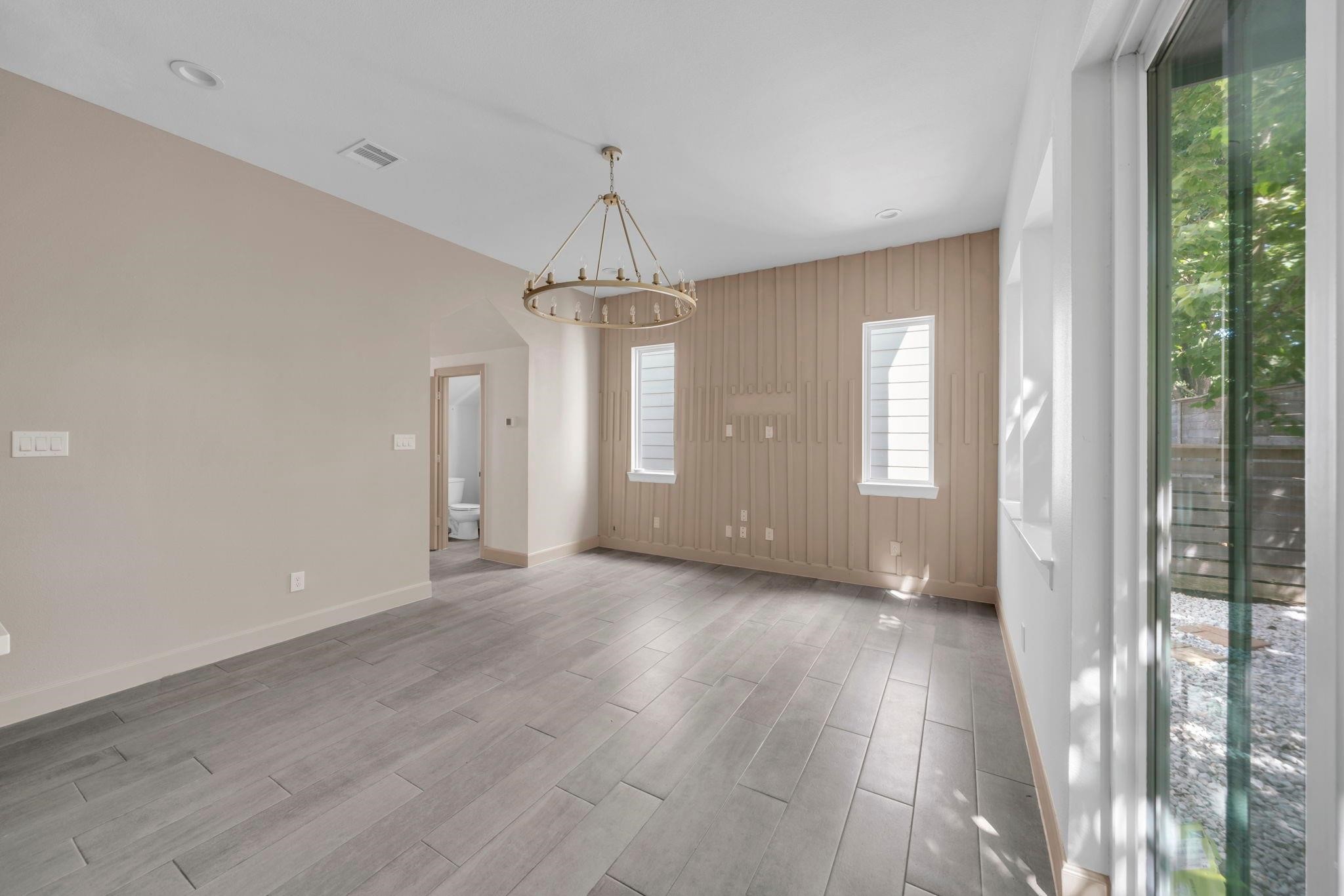 9551 Neuens Road, Unit B Houston, TX 77080 - Photo 6 of 34 wooden floor in an empty room with a window
