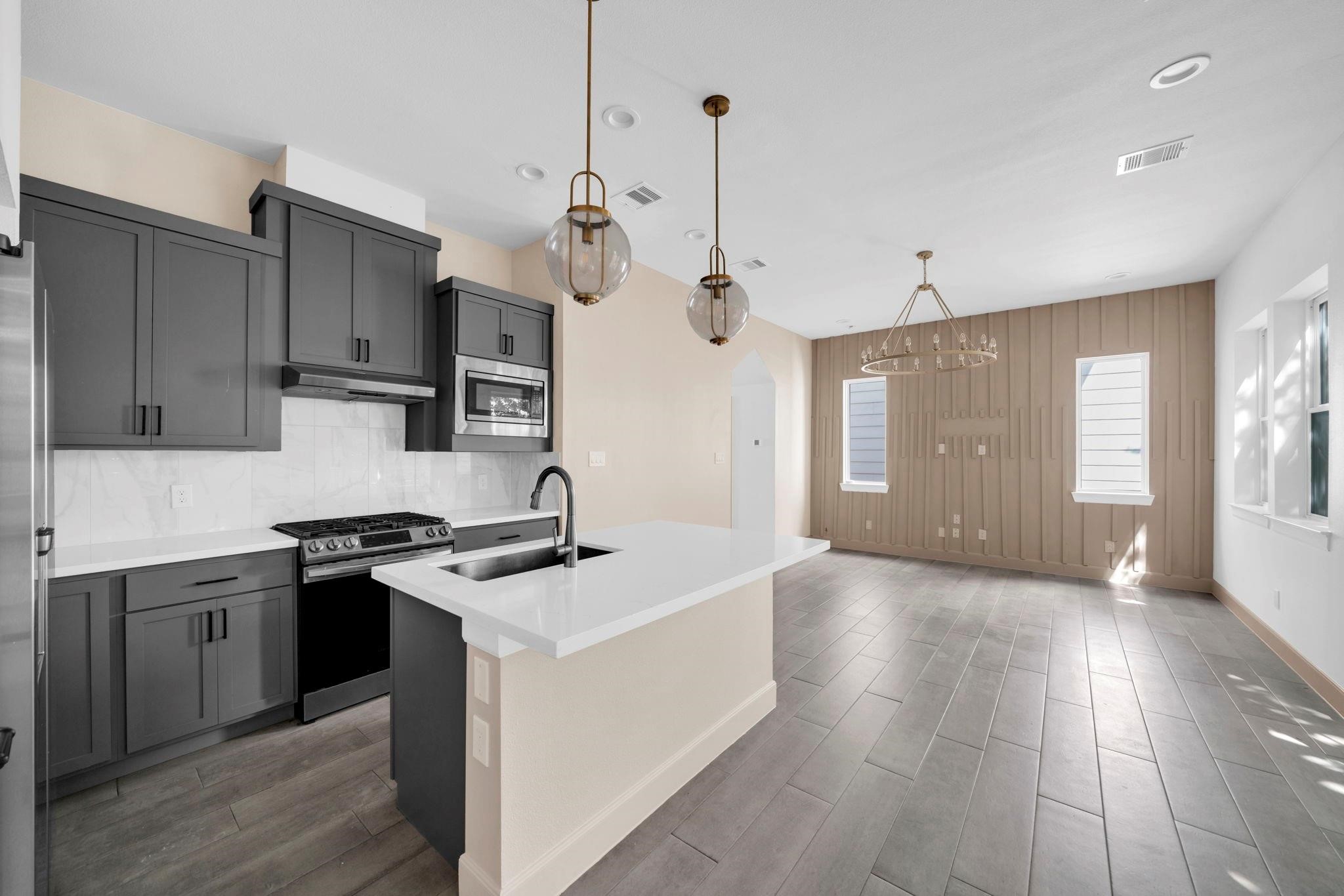9551 Neuens Road, Unit B Houston, TX 77080 - Photo 9 of 34 a kitchen with stainless steel appliances granite countertop a sink a stove and a refrigerator