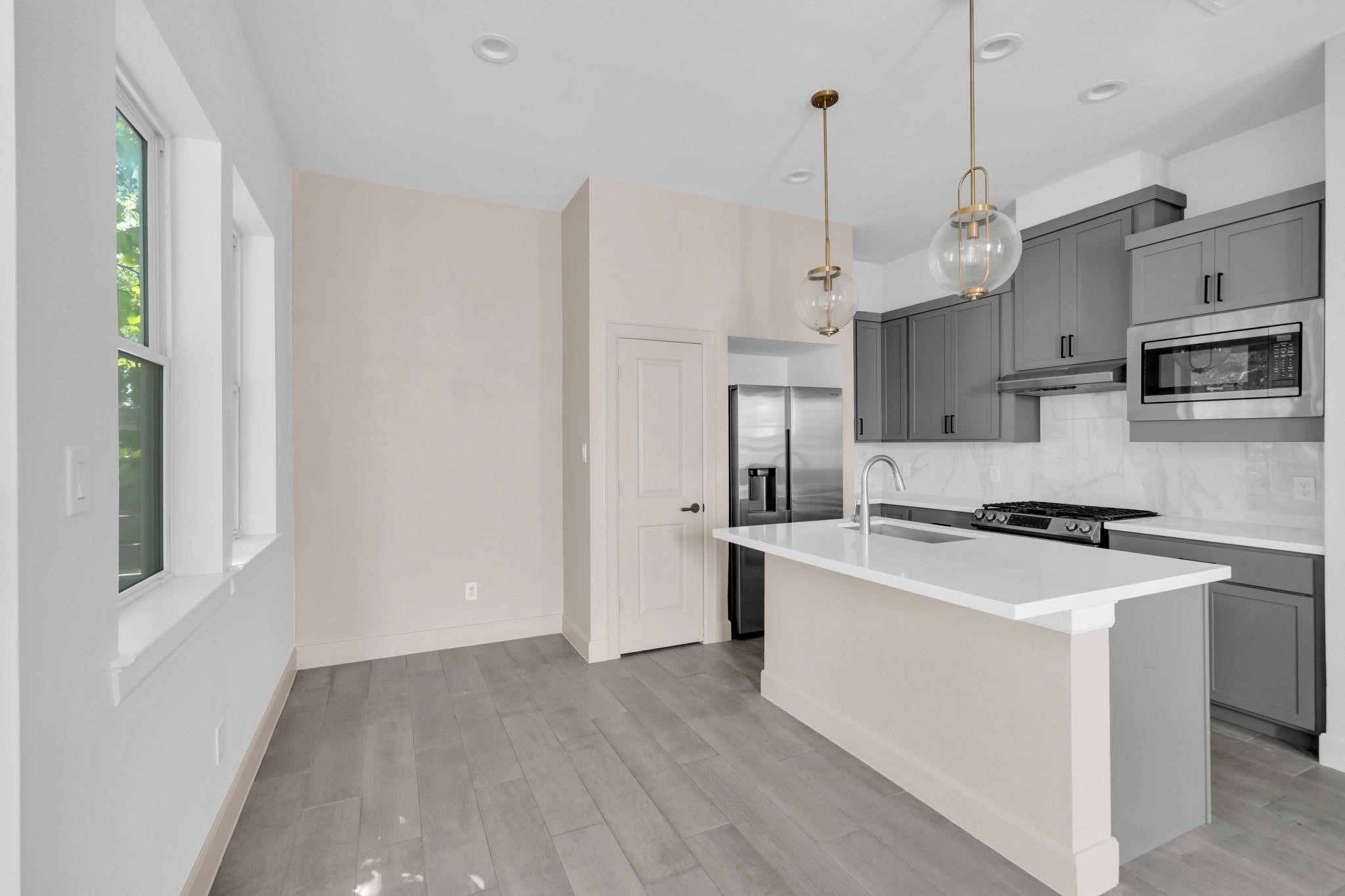 9551 Neuens Road, Unit B Houston, TX 77080 - Photo 10 of 34 a kitchen that has a lot of cabinets a sink and a stove