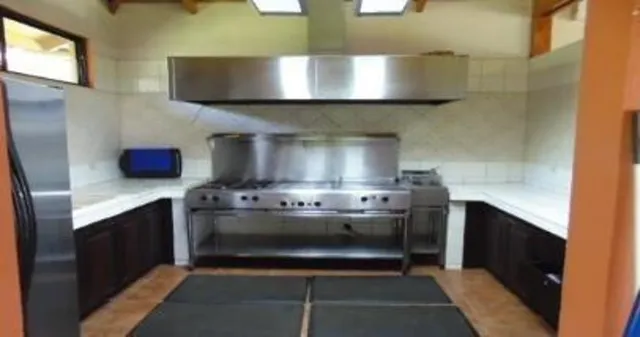 a stove top oven sitting inside of a kitchen