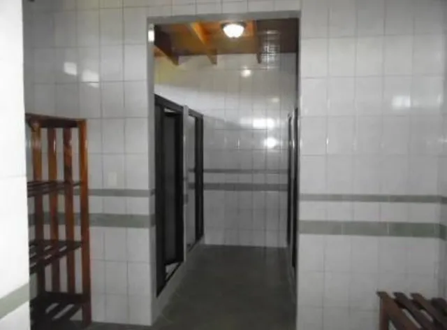 a bathroom with a glass shower door and a bathroom