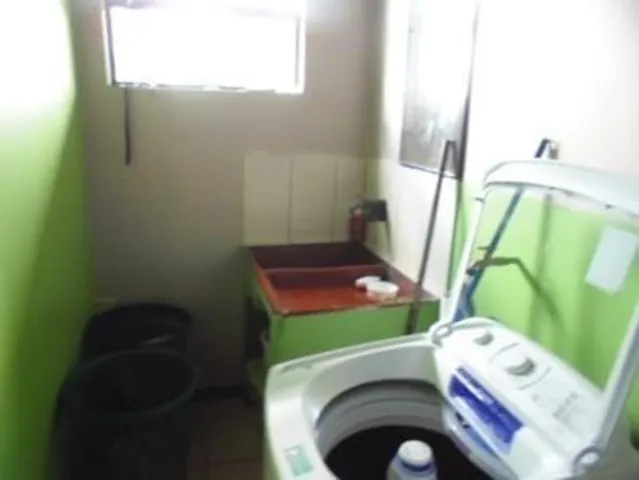 a bathroom with a sink toilet and window