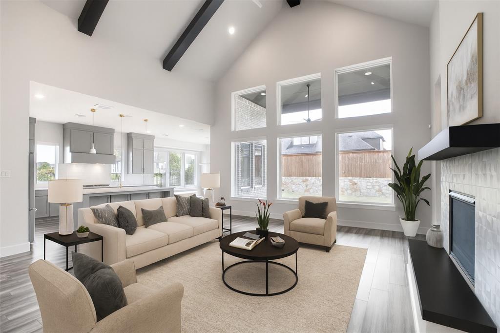 a living room with furniture fireplace and a large window