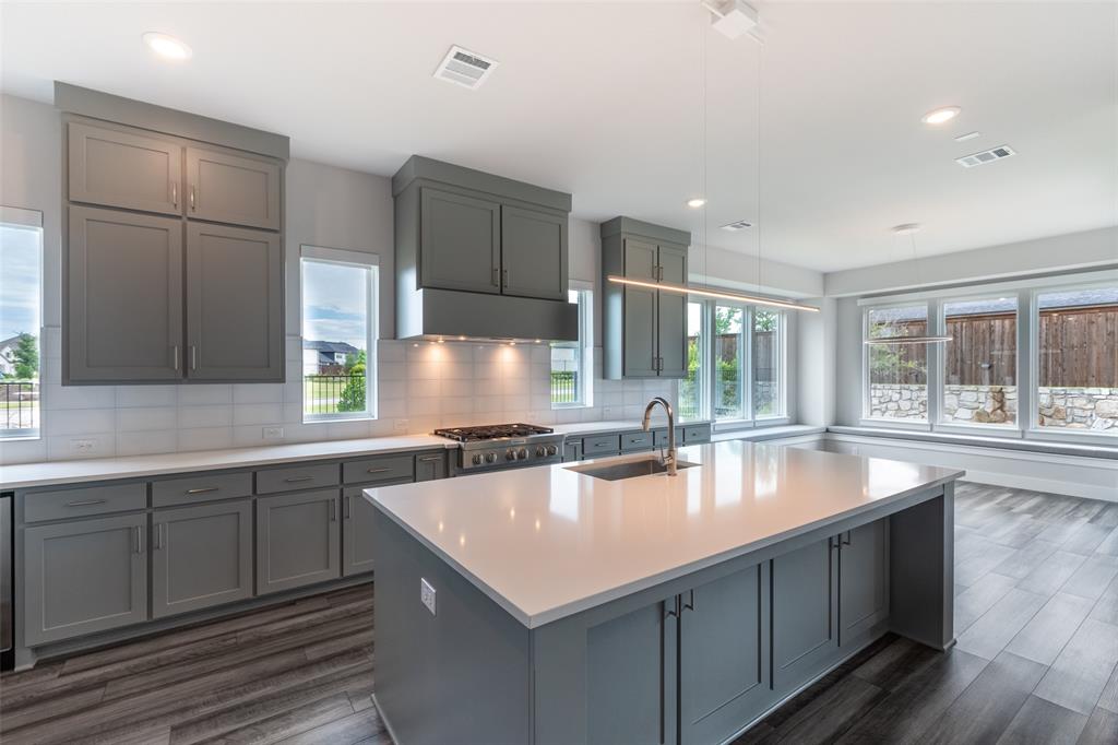 8003 Splitbeard Road Frisco, TX 75035 - Photo 13 of 40 a kitchen with a stove a sink and a refrigerator