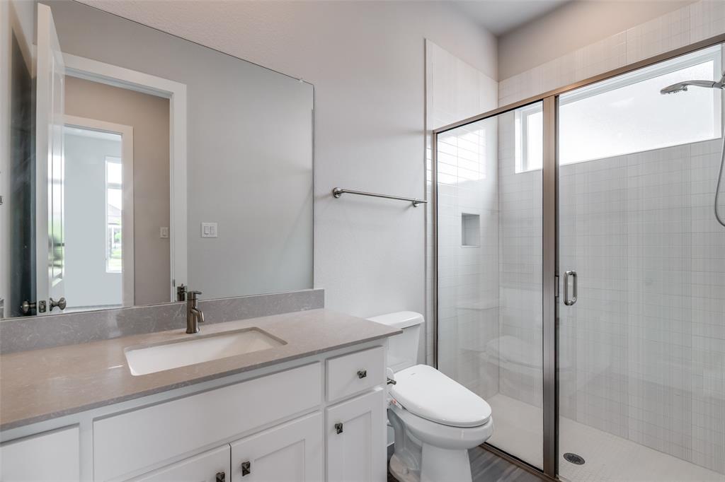 8003 Splitbeard Road Frisco, TX 75035 - Photo 21 of 40 a bathroom with a sink toilet and shower