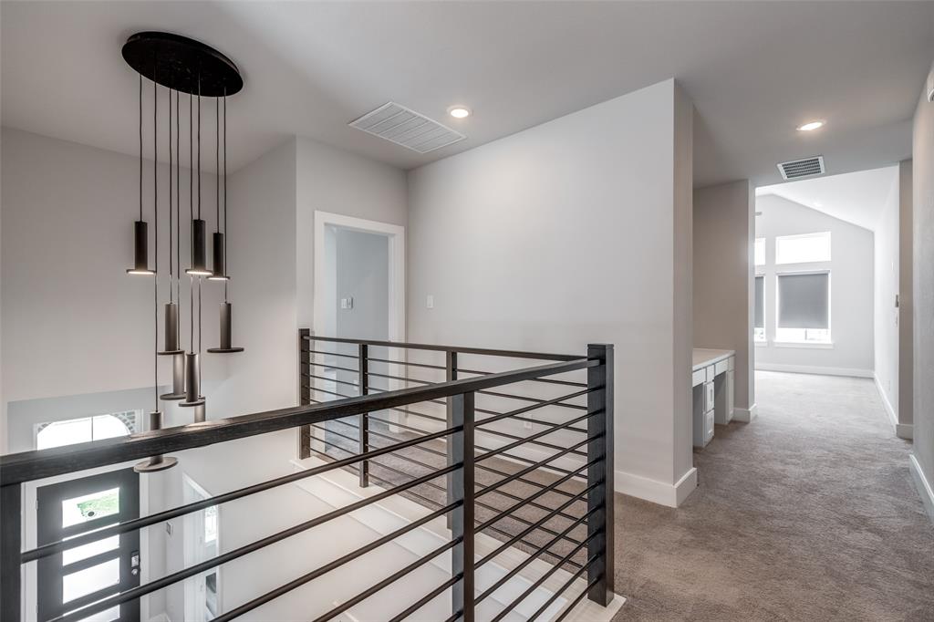8003 Splitbeard Road Frisco, TX 75035 - Photo 29 of 40 a view of a hallway with a sink and furniture