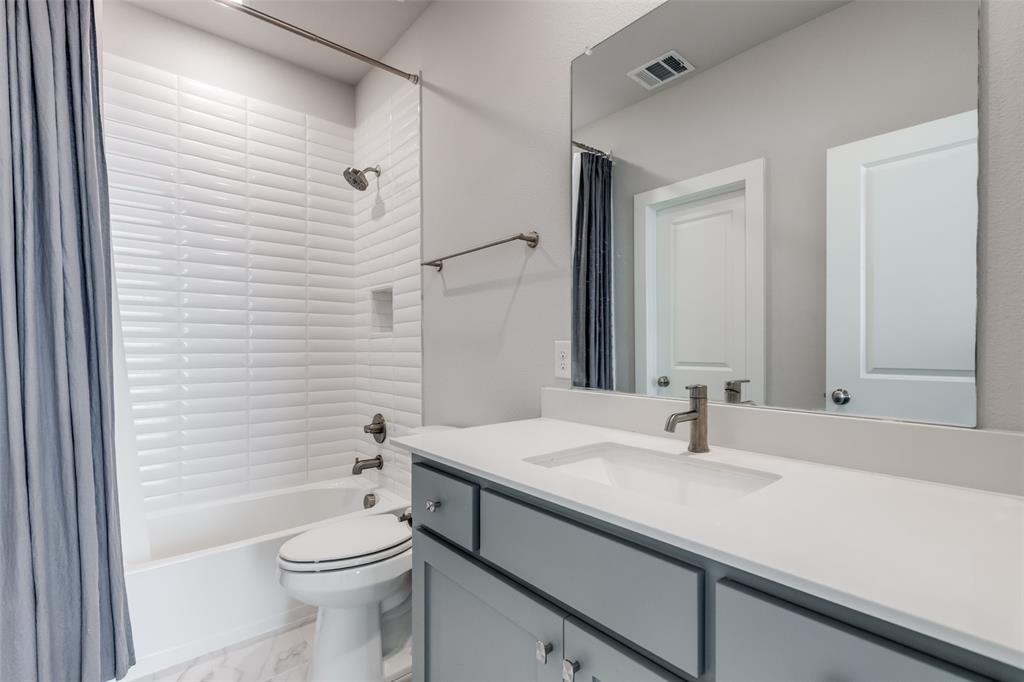 8003 Splitbeard Road Frisco, TX 75035 - Photo 33 of 40 a bathroom with a sink a toilet and shower