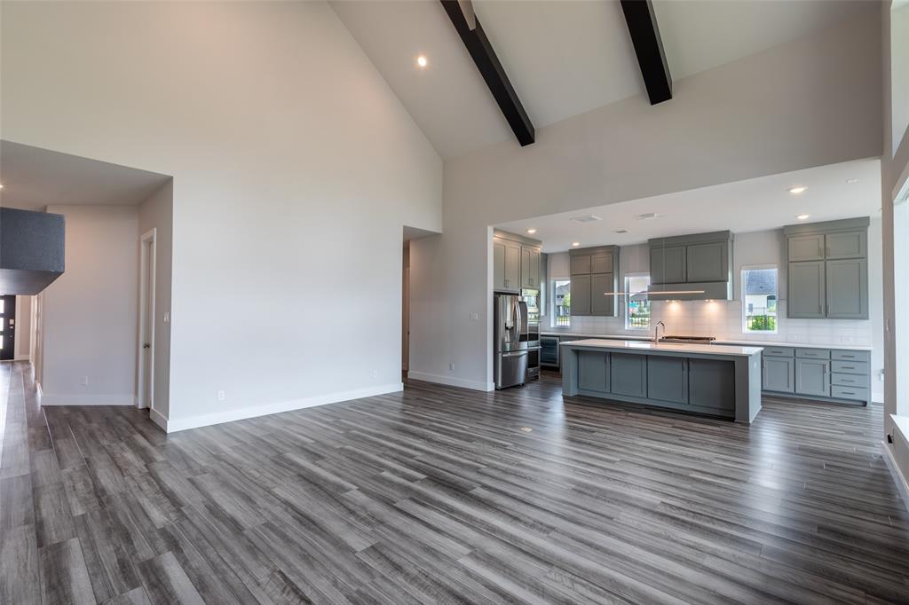 8003 Splitbeard Road Frisco, TX 75035 - Photo 10 of 40 a large kitchen with stainless steel appliances granite countertop a large counter top and wooden floors