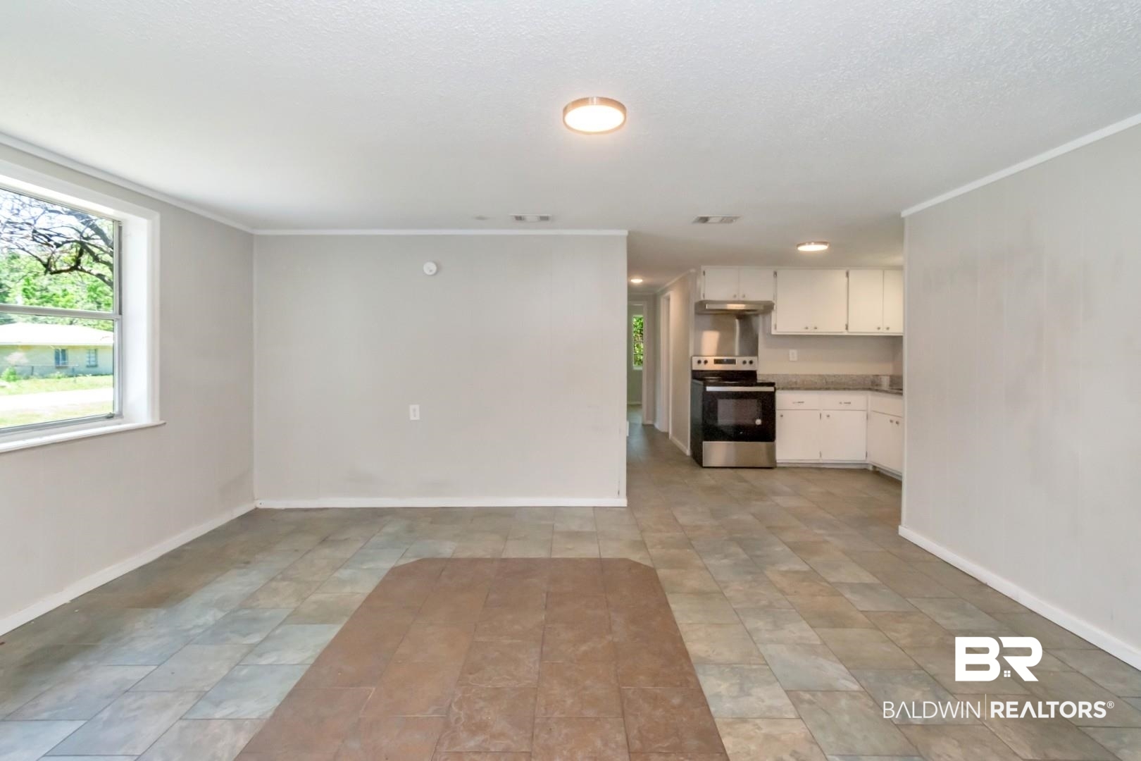 5650 Alice Drive Theodore, AL 36582 - Photo 4 of 15 Unfurnished living room featuring baseboards and ornamental molding