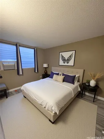 a spacious bedroom with a bed and window