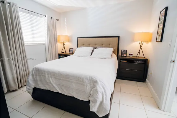 a bedroom with a bed and a mirror