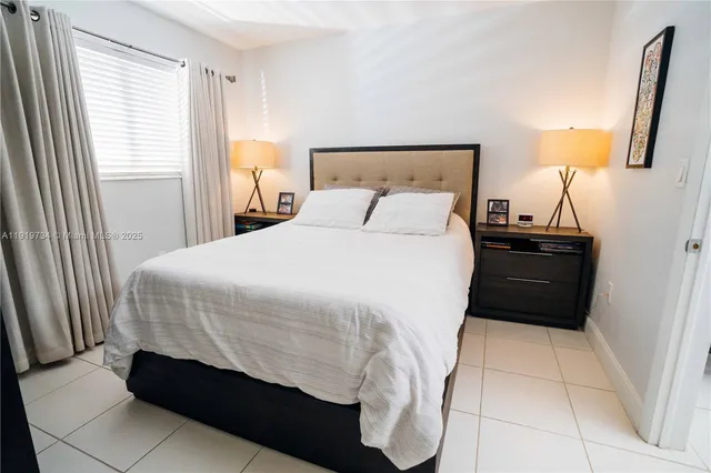 a bedroom with a bed and a mirror