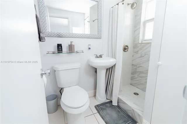 a bathroom with a toilet sink and shower