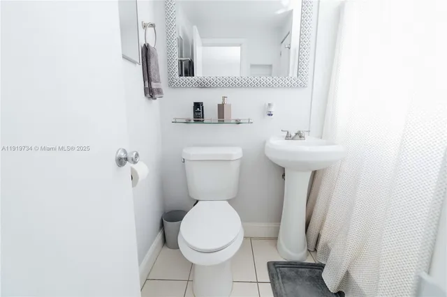 a white toilet sitting next to a bathroom sink