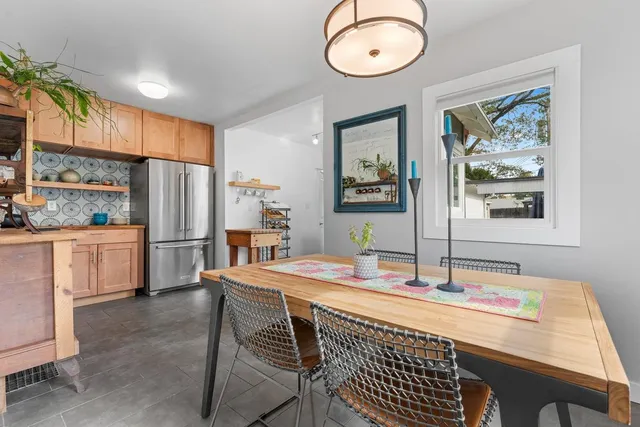 a kitchen with stainless steel appliances kitchen island granite countertop a sink refrigerator and cabinets