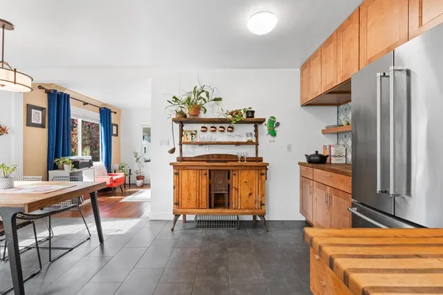 a kitchen with stainless steel appliances kitchen island granite countertop a stove a sink and a refrigerator