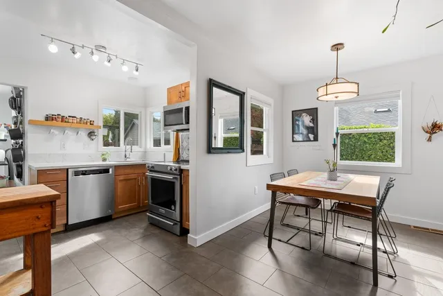 a kitchen that has a table and chairs in it