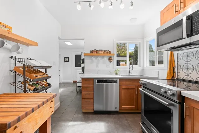 a kitchen with stainless steel appliances granite countertop a stove and a sink