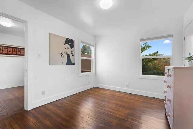 an empty room with wooden floor