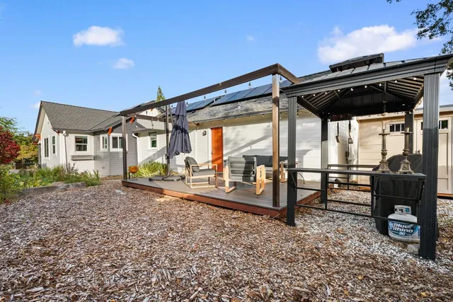 a backyard of a house with a garden and plants