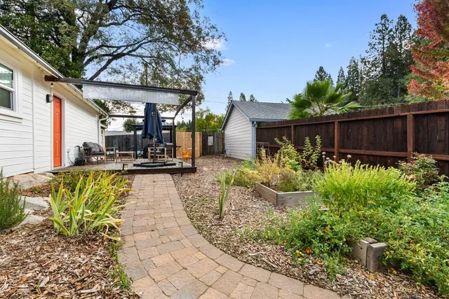 an aerial view of a house with a yard and furniture