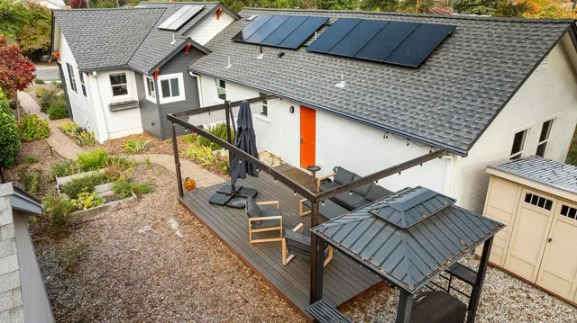 a view of a house with a yard and garden