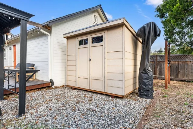 a front view of a house with a yard and potted plants