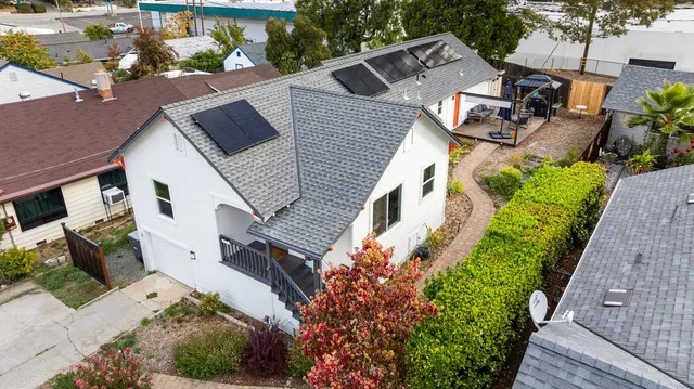 an aerial view of a house with a yard and potted plants
