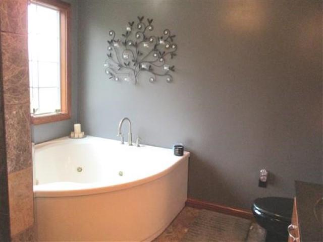 1406 Joe Williams Road Loretto, TN 38469 - Photo 14 of 20 a white bath tub sitting in a bathroom next to a window