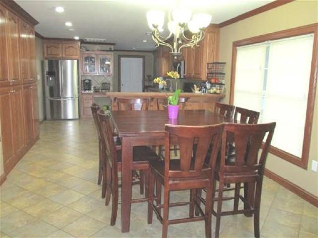 1406 Joe Williams Road Loretto, TN 38469 - Photo 4 of 20 a dining room with furniture a chandelier and kitchen view