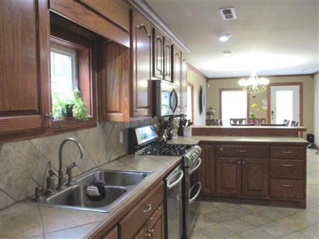 1406 Joe Williams Road Loretto, TN 38469 - Photo 5 of 20 a kitchen with a sink stove top oven and cabinets
