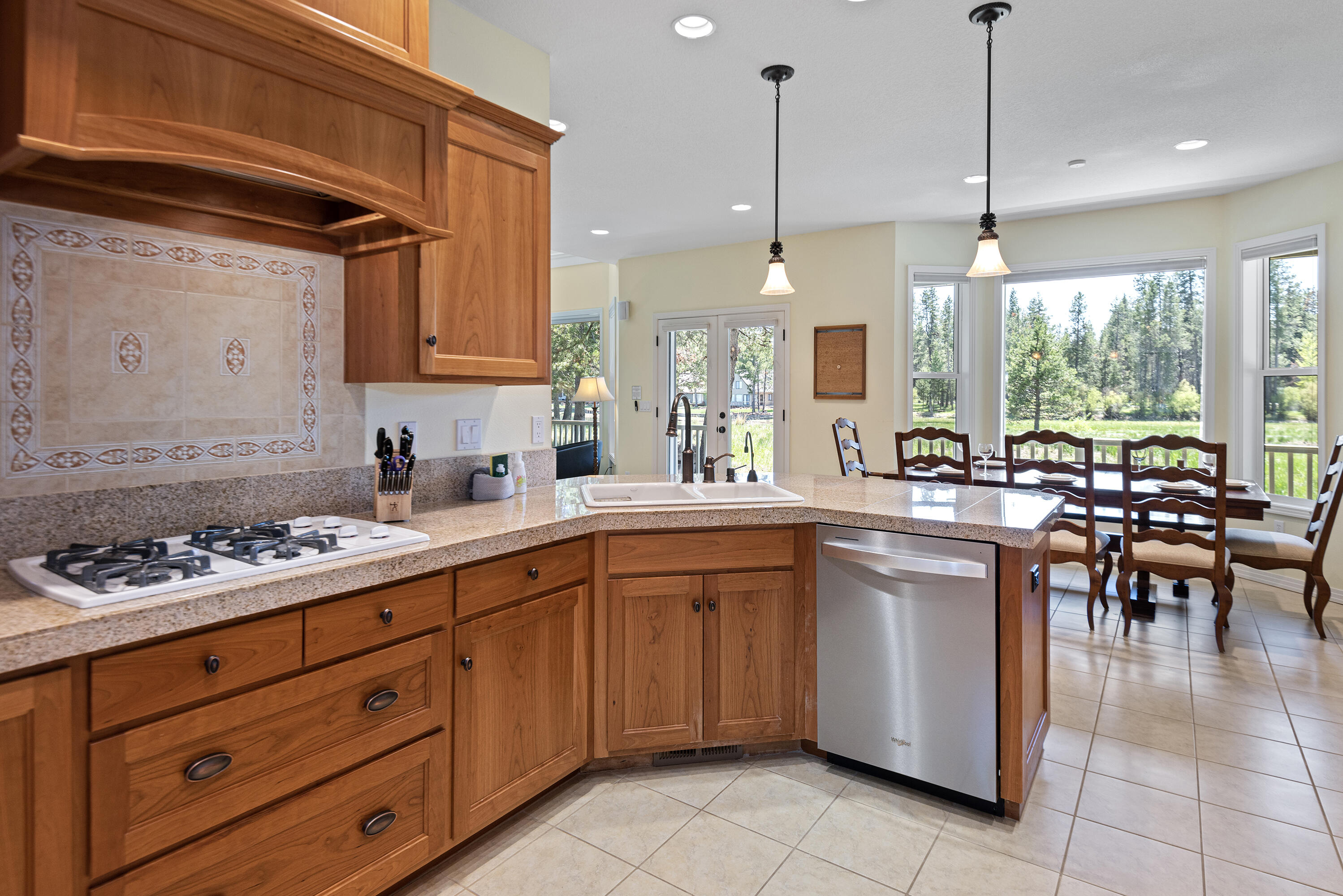 16775 Pony Express Way Bend, OR 97707 - Photo 6 of 38 a kitchen with a sink counter top space appliances and cabinets