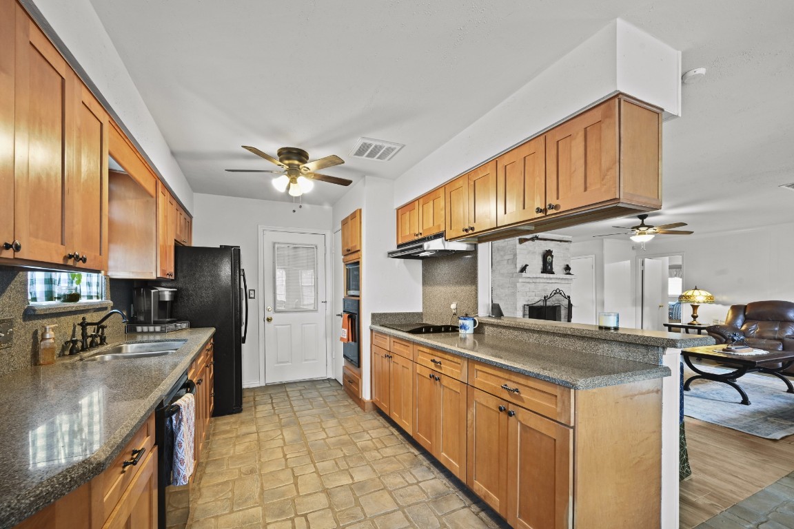 13823 Wickersham Lane Houston, TX 77077 - Photo 12 of 24 a kitchen with stainless steel appliances granite countertop a sink a stove and a refrigerator