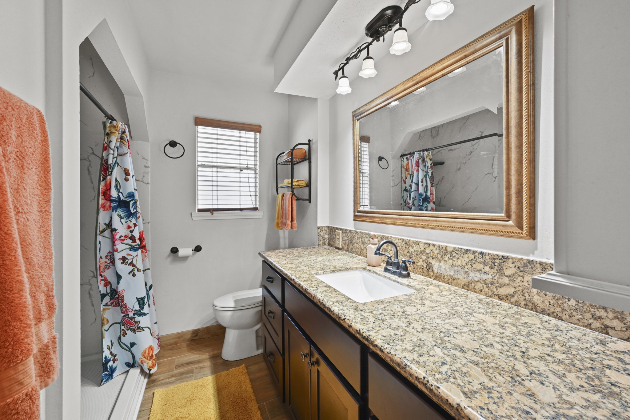 13823 Wickersham Lane Houston, TX 77077 - Photo 15 of 24 a bathroom with a granite countertop sink a mirror a vanity and a shower