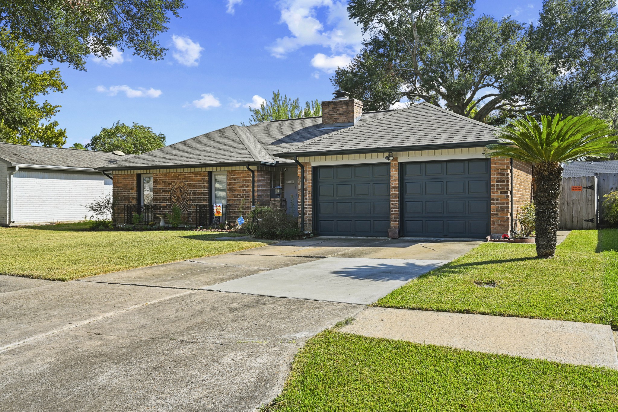 13823 Wickersham Lane Houston, TX 77077 - Photo 3 of 24 a front view of a house with a yard and garage
