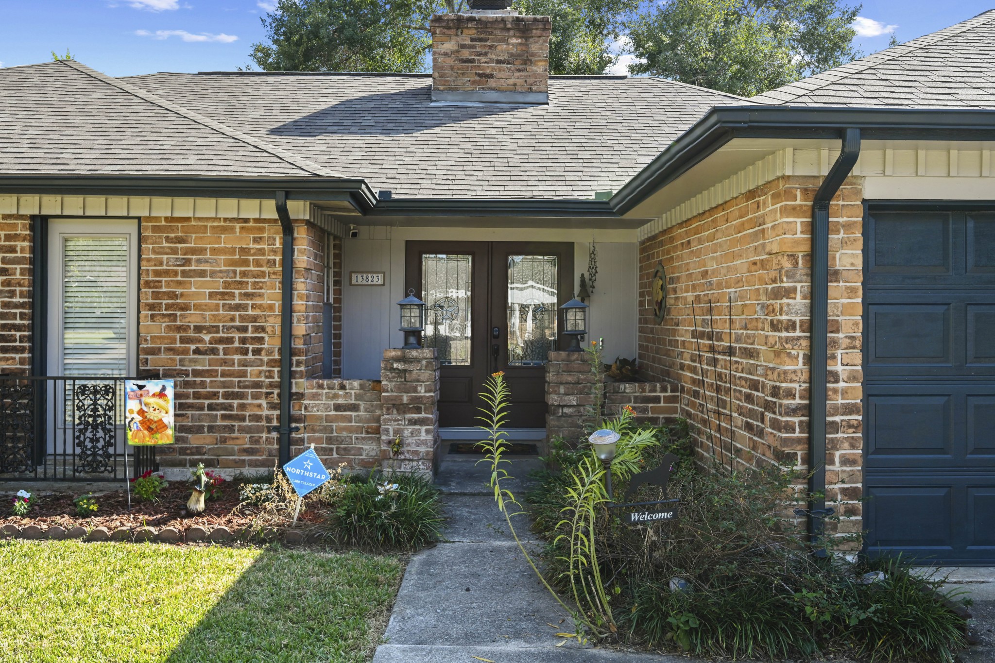 13823 Wickersham Lane Houston, TX 77077 - Photo 4 of 24 a front view of a house with garden