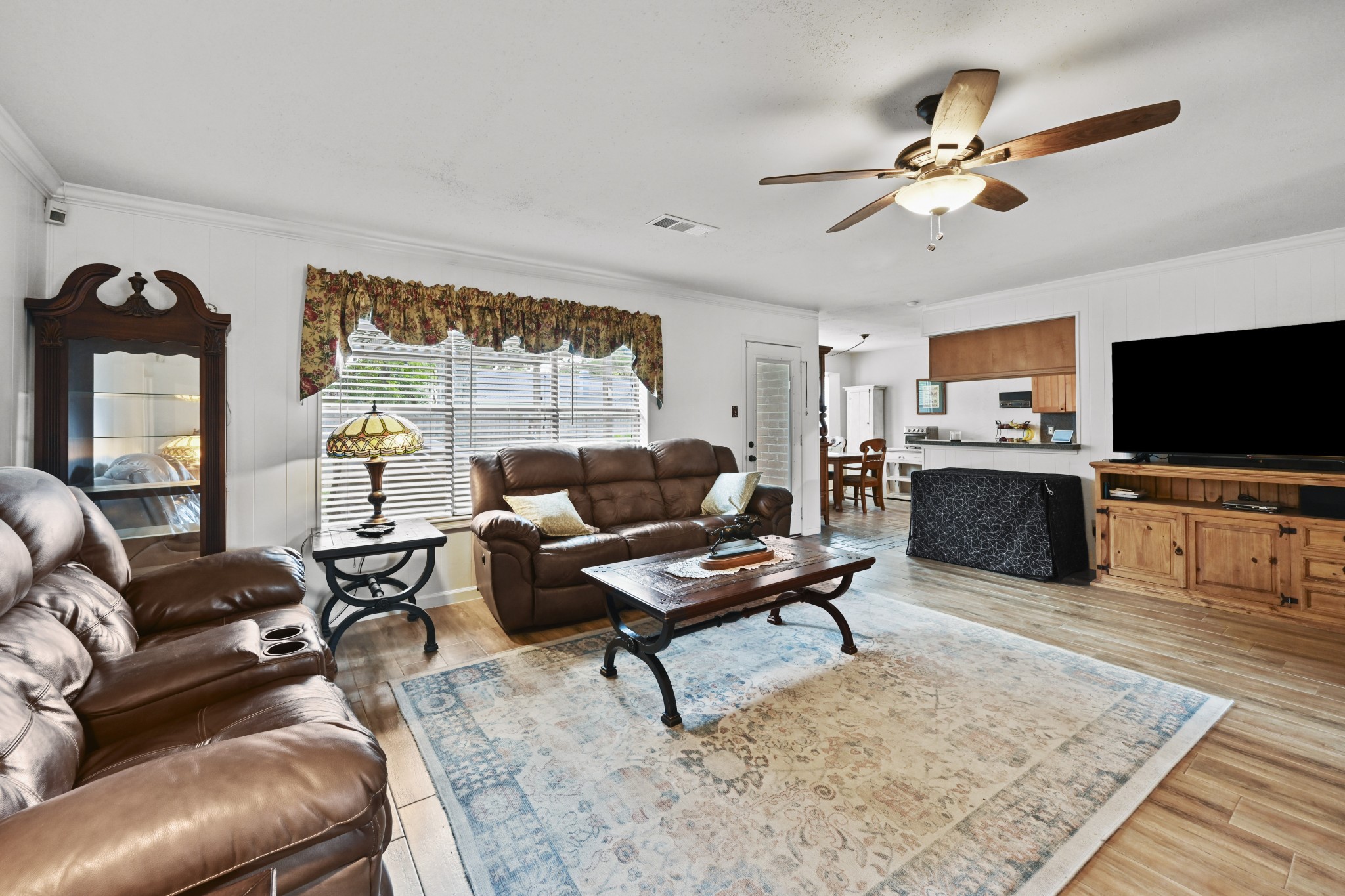 13823 Wickersham Lane Houston, TX 77077 - Photo 8 of 24 a living room with furniture and a flat screen tv