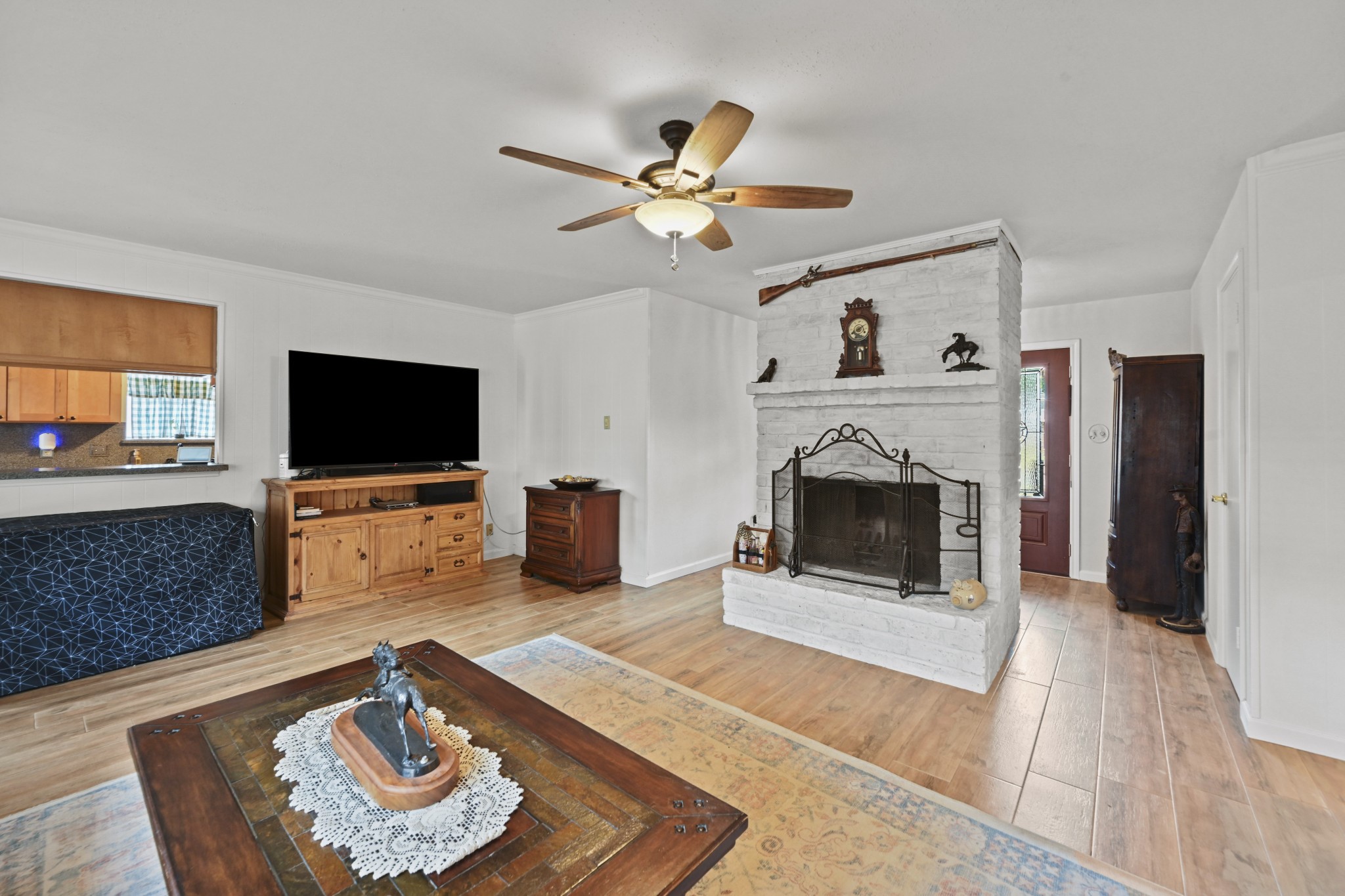 13823 Wickersham Lane Houston, TX 77077 - Photo 9 of 24 a living room with furniture and a fireplace