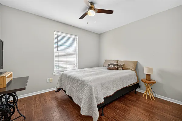 a bed sitting in a bedroom next to a window