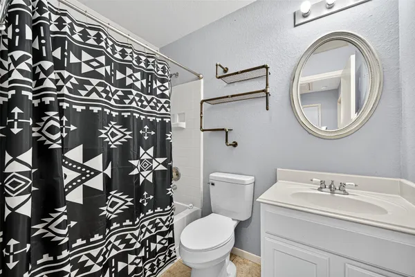 a white toilet sitting next to a bathroom sink
