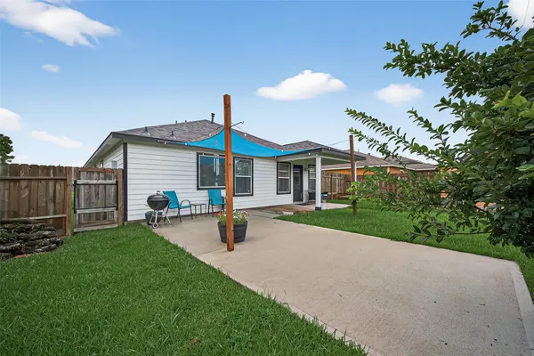 a front view of a house with a garden and yard