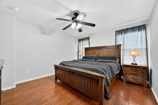 a bedroom with a bed and a ceiling fan