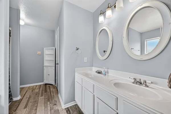 a bathroom with a double vanity sink and a mirror