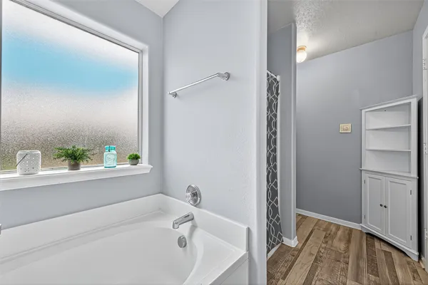 a bathroom with a bathtub and a sink