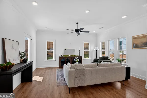a living room with furniture and wooden floor