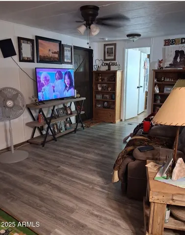 a bedroom with furniture and a flat screen tv