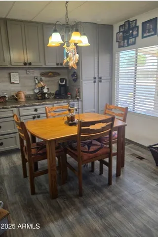a sink with granite countertop white cabinets and a sink