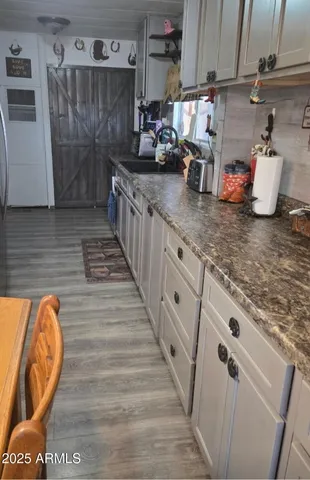 a kitchen with stainless steel appliances granite countertop a refrigerator and a stove