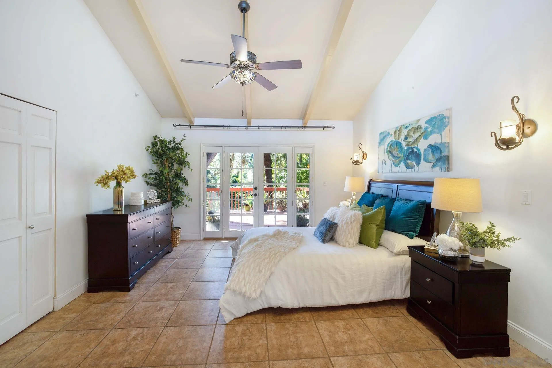 7671 La Brisa Rancho Santa Fe, CA 92067 - Photo 11 of 34 a bedroom with a large bed and a chandelier